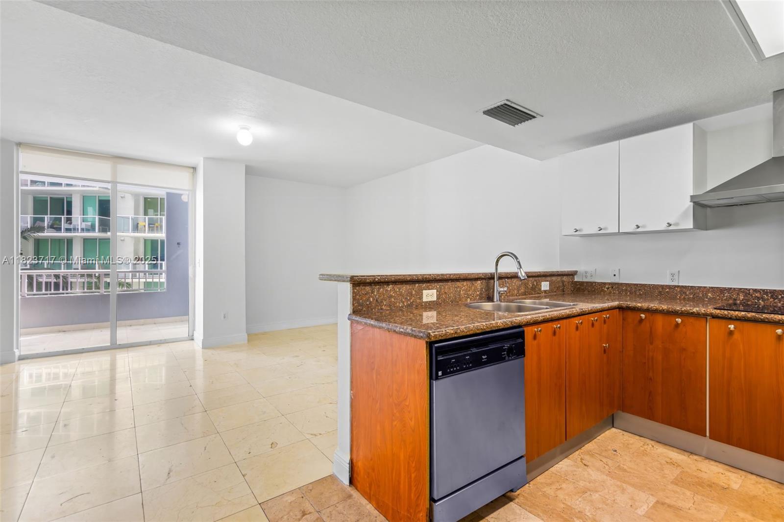 170 Southeast 14th Street, Unit 1203 Miami, FL 33131 - Photo 6 of 24 a kitchen with stainless steel appliances granite countertop a sink stove and cabinets