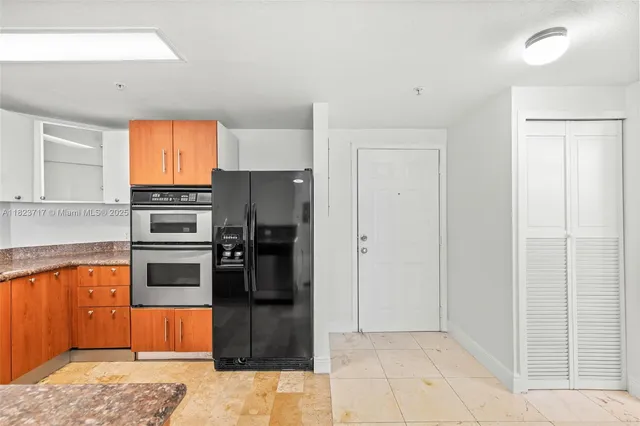 a kitchen with stainless steel appliances granite countertop a refrigerator and a sink