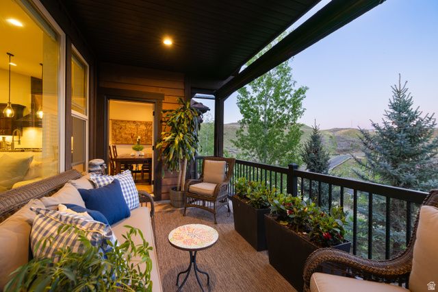 1737 East Viewside Circle Hideout, UT 84036 - Photo 11 of 35 Covered outdoor balcony featuring a dark wood ceiling, wood-finish siding, and a black railing