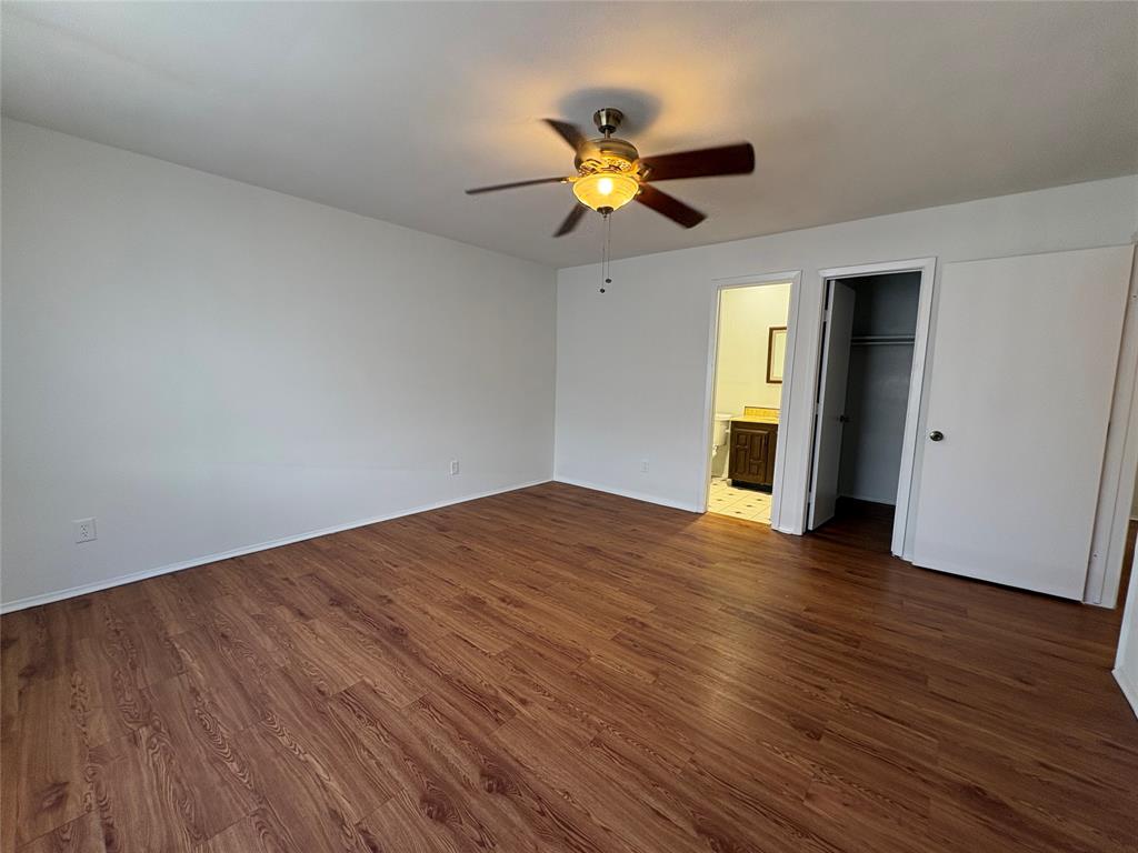 7226 Little Canyon Road Dallas, TX 75249 - Photo 18 of 30 a view of empty room with wooden floor and fan