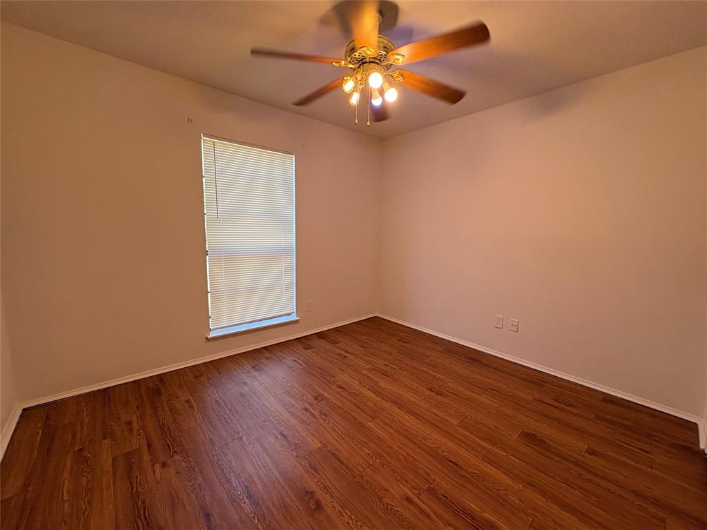 7226 Little Canyon Road Dallas, TX 75249 - Photo 23 of 30 a view of an empty room with wooden floor