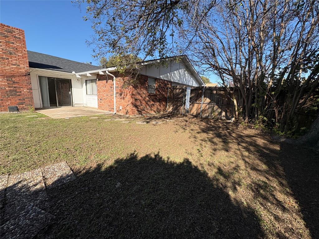 7226 Little Canyon Road Dallas, TX 75249 - Photo 29 of 30 a view of a house with a yard