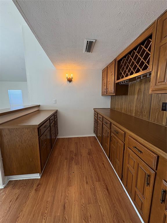7226 Little Canyon Road Dallas, TX 75249 - Photo 9 of 30 a kitchen with wooden floors and a sink