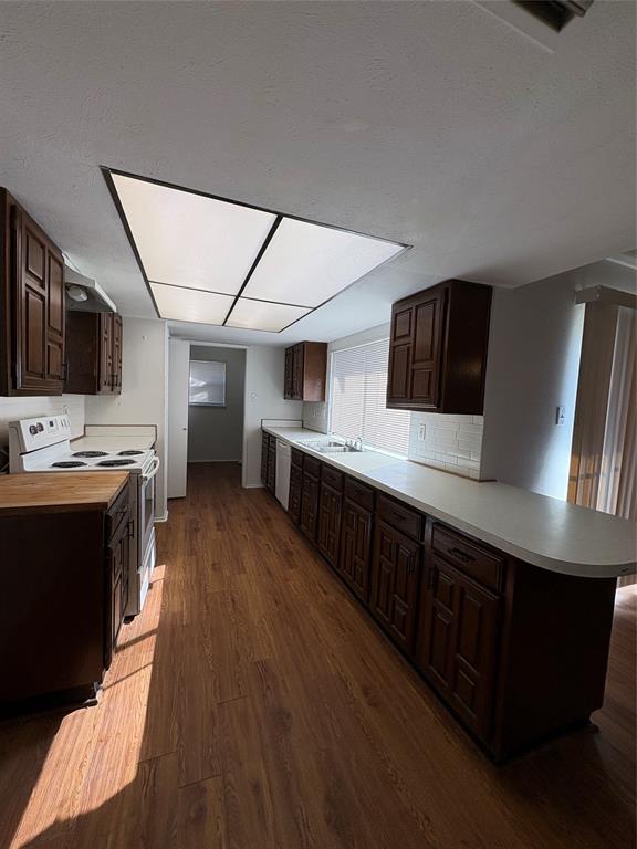 7226 Little Canyon Road Dallas, TX 75249 - Photo 10 of 30 a large kitchen with stainless steel appliances a stove a sink dishwasher and a black refrigerator