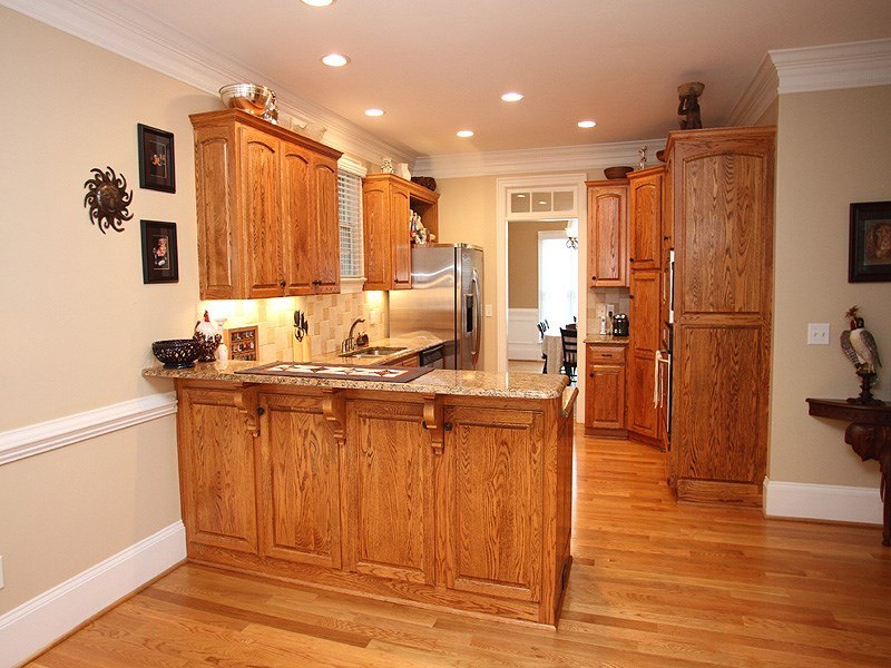 3710 Congeniality Way Raleigh, NC 27613 - Photo 5 of 23 Cook's kitchen with granite, tile backsplash, hardwoods, crown molding, gas cooktop, built in wall oven and microwave. Kitchen