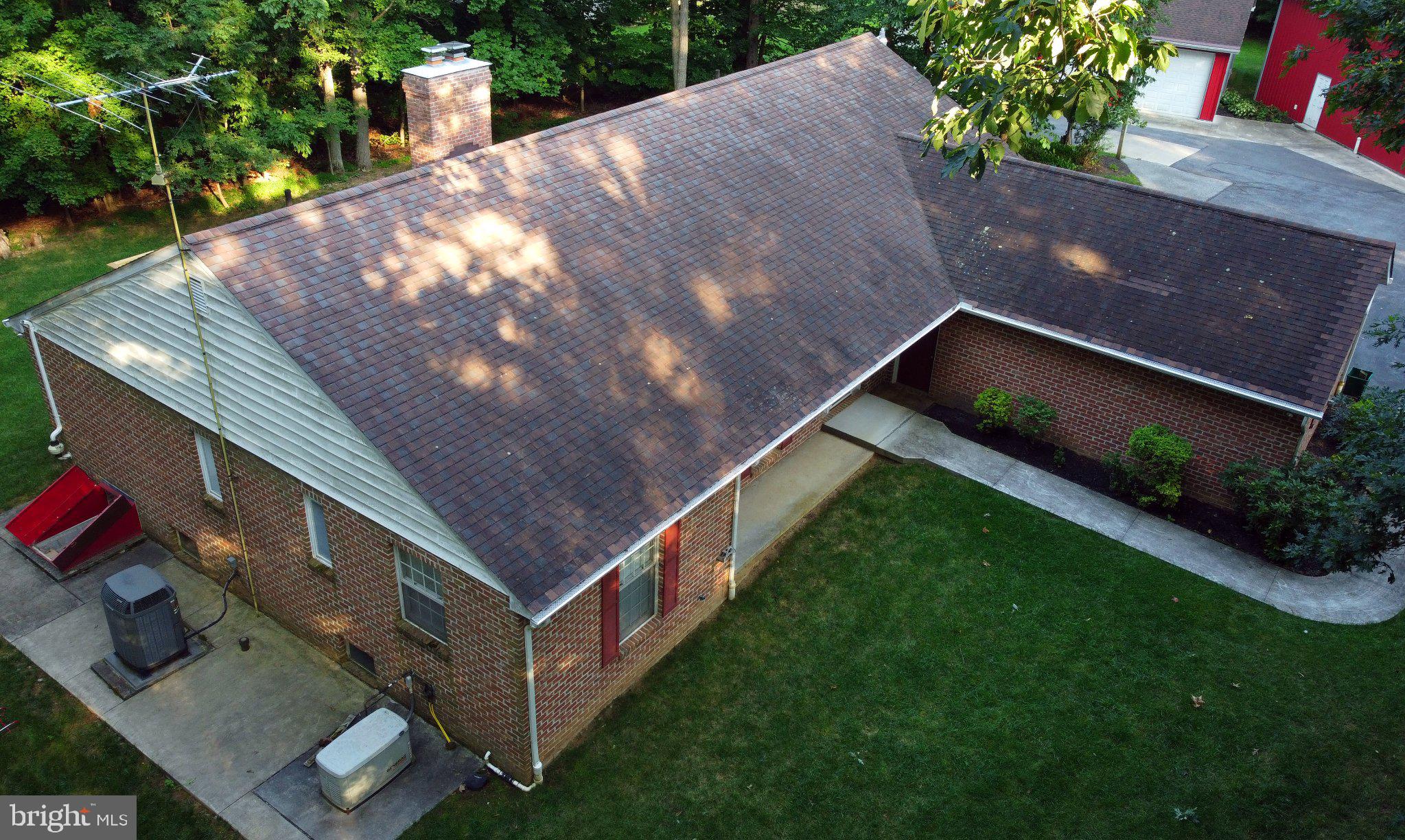 Charming brick home nestled in greenery.