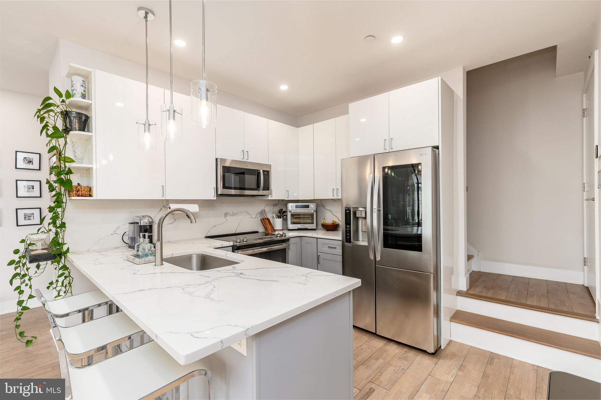 1733 Carpenter Street, Unit D Philadelphia, PA 19146 - Photo 10 of 37 a kitchen with a sink a counter top space cabinets and stainless steel appliances