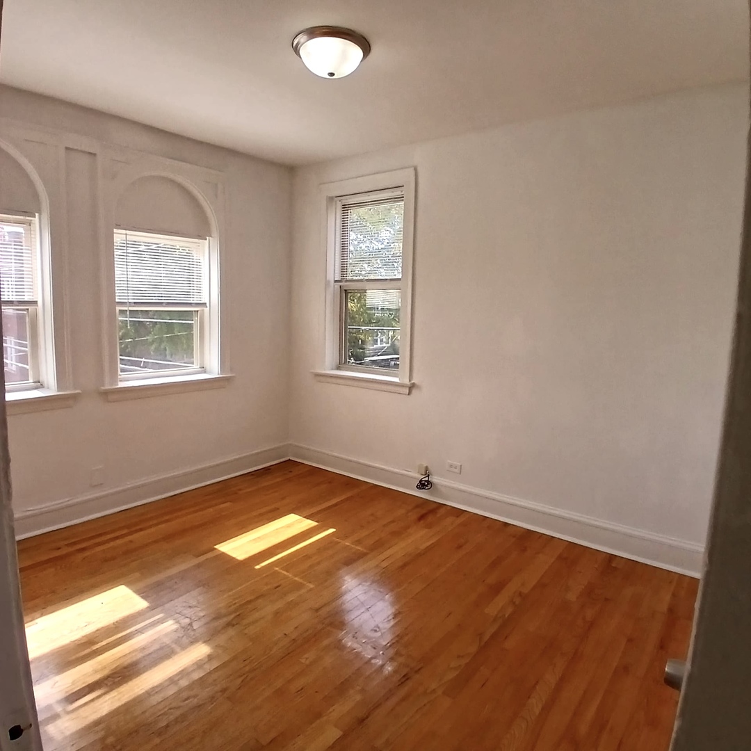 4808 West Barry Avenue, Unit 2W Chicago, IL 60641 - Photo 2 of 11 a view of an empty room and window