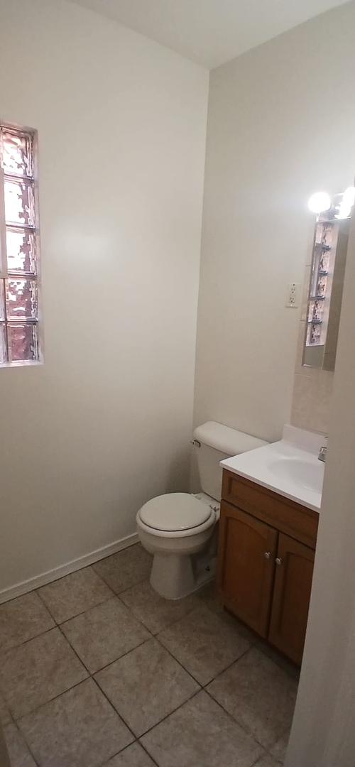 4808 West Barry Avenue, Unit 2W Chicago, IL 60641 - Photo 10 of 11 a bathroom with a toilet and a sink