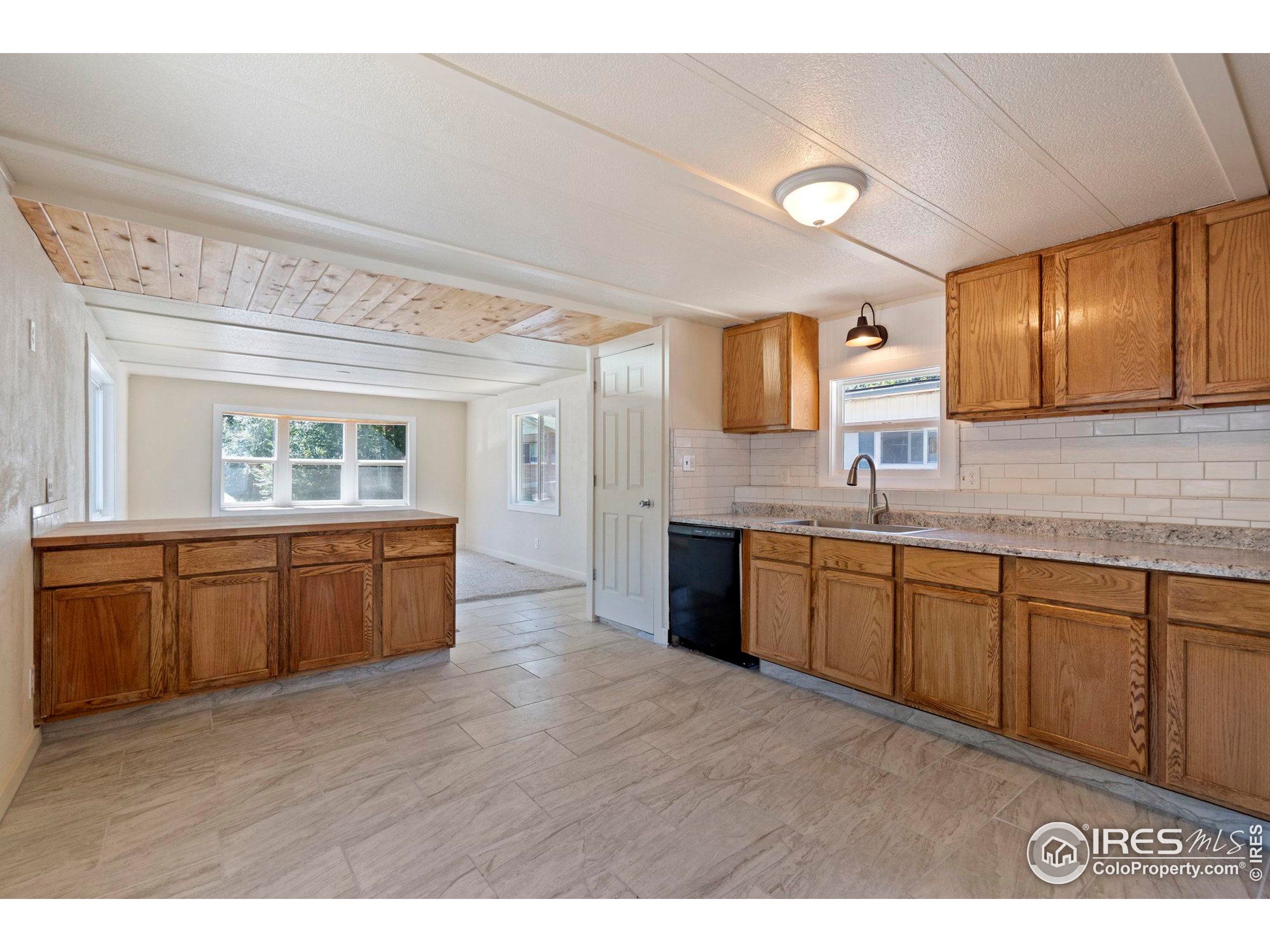 400 South Overland Trail, Unit 6 Fort Collins, CO 80521 - Photo 11 of 21 a kitchen with a sink cabinets and wooden floor