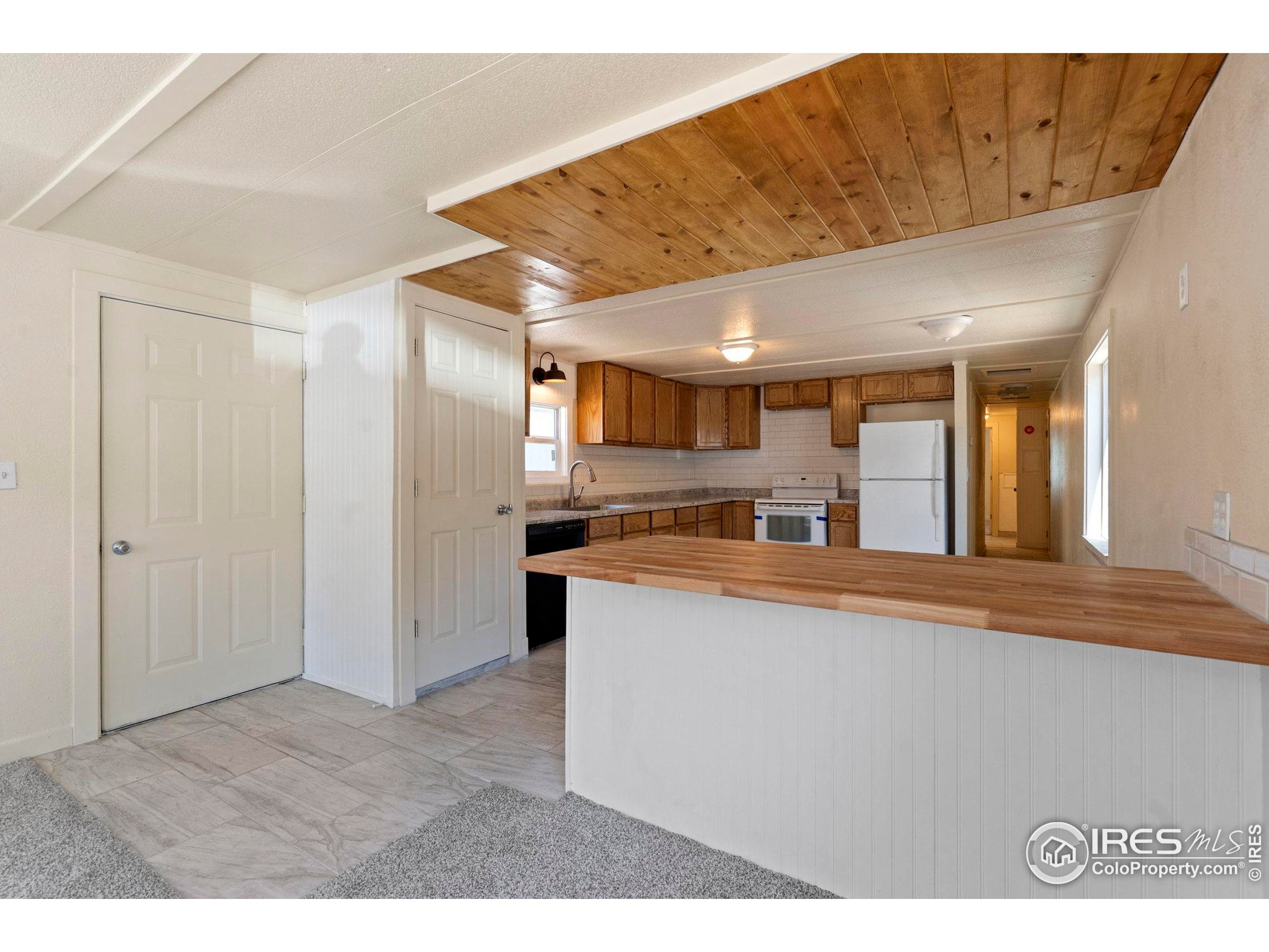 400 South Overland Trail, Unit 6 Fort Collins, CO 80521 - Photo 10 of 21 a living room with stainless steel appliances kitchen island a sink cabinets and wooden floor