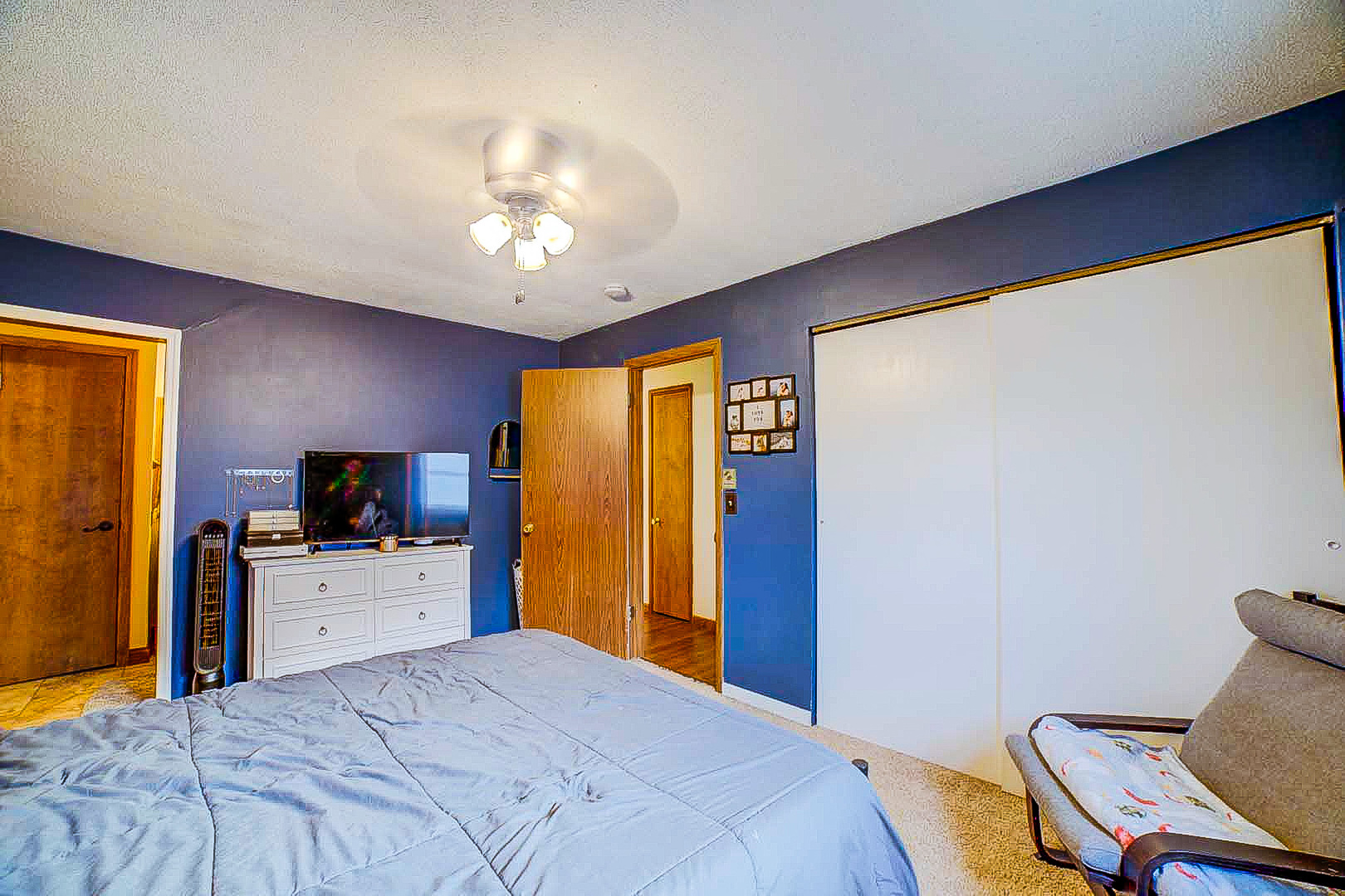 708 Sycamore Street Watseka, IL 60970 - Photo 19 of 25 a bedroom with a bed and a flat screen tv