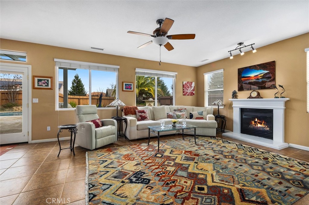 795 Angus Street Paso Robles, CA 93446 - Photo 12 of 75 a living room with furniture fireplace and a flat screen tv