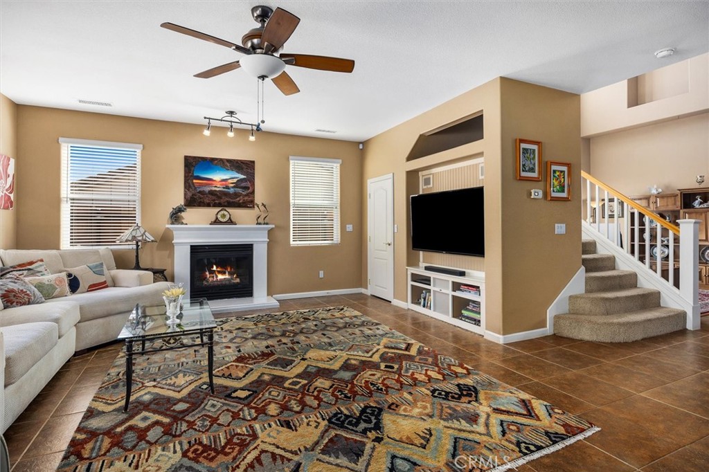 795 Angus Street Paso Robles, CA 93446 - Photo 13 of 75 a living room with furniture a flat screen tv and a fireplace