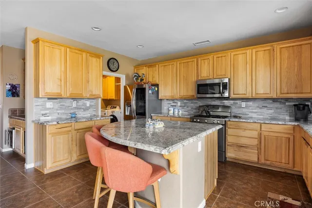 a kitchen with a refrigerator sink and cabinets
