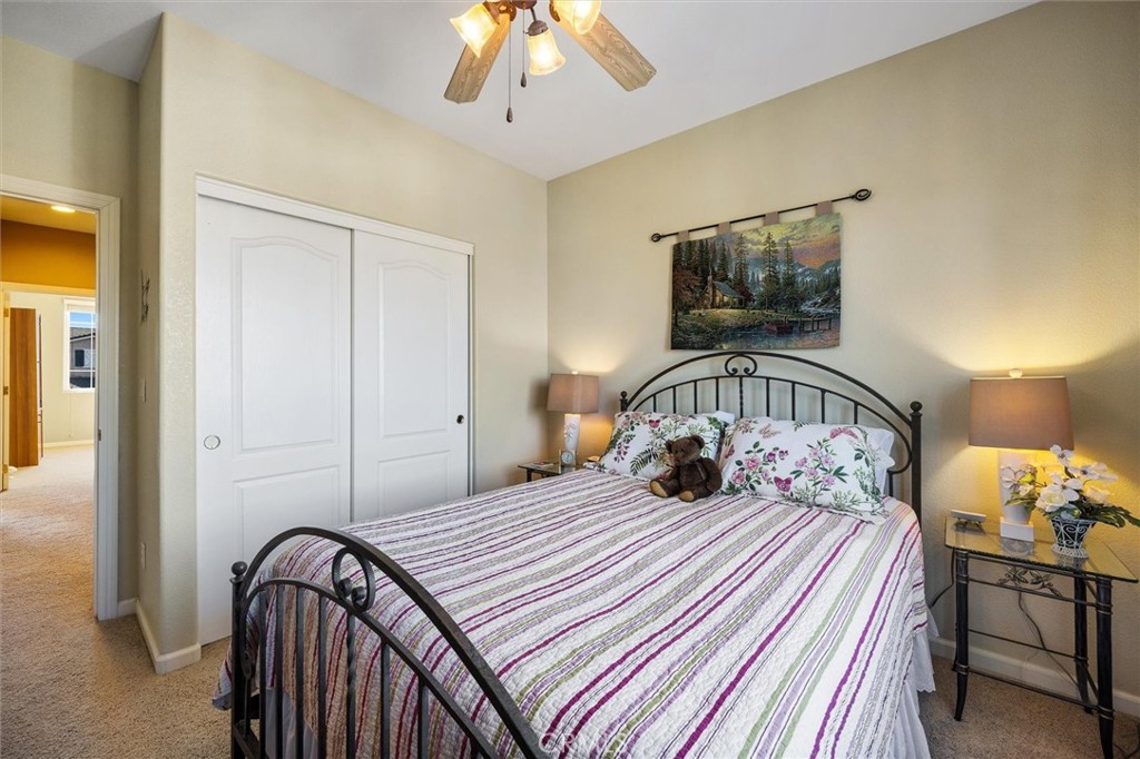 795 Angus Street Paso Robles, CA 93446 - Photo 33 of 75 a bedroom with a bed and a chandelier