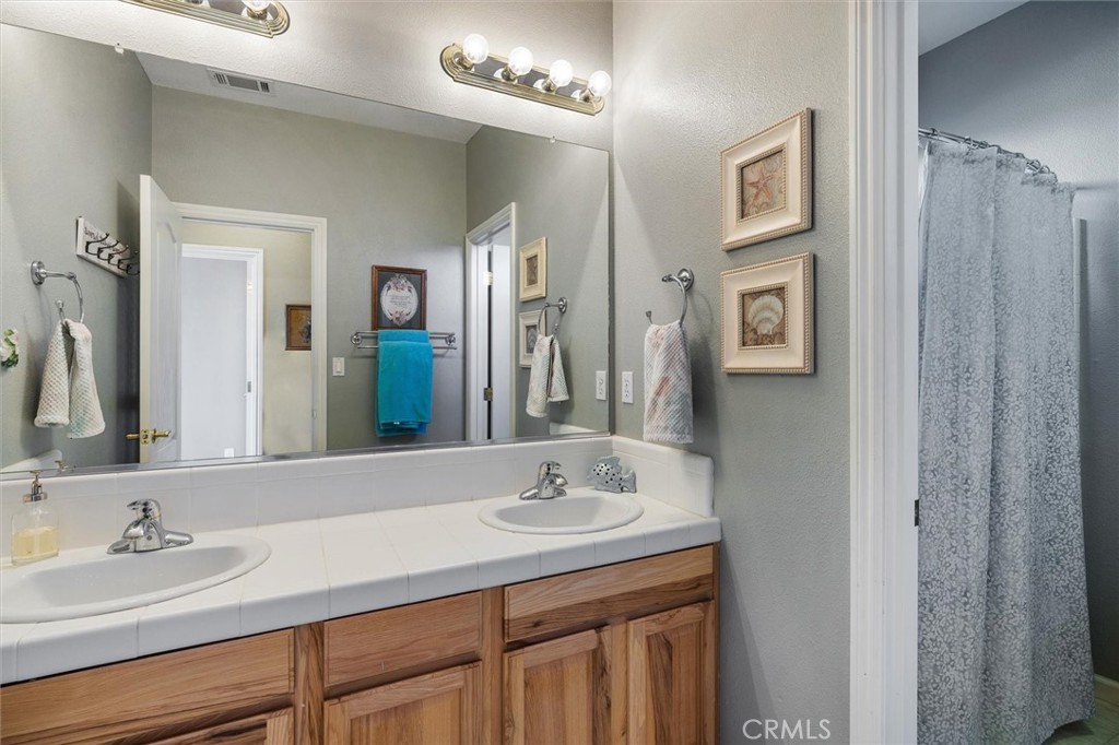 795 Angus Street Paso Robles, CA 93446 - Photo 34 of 75 a bathroom with a granite countertop sink and a mirror