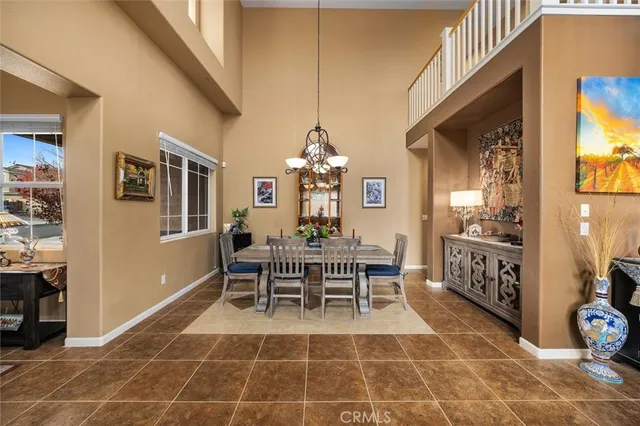 a view of a dining room with furniture and chandelier