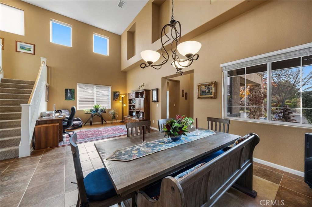 795 Angus Street Paso Robles, CA 93446 - Photo 7 of 75 a dining room with wooden floor a chandelier a wooden table and chairs