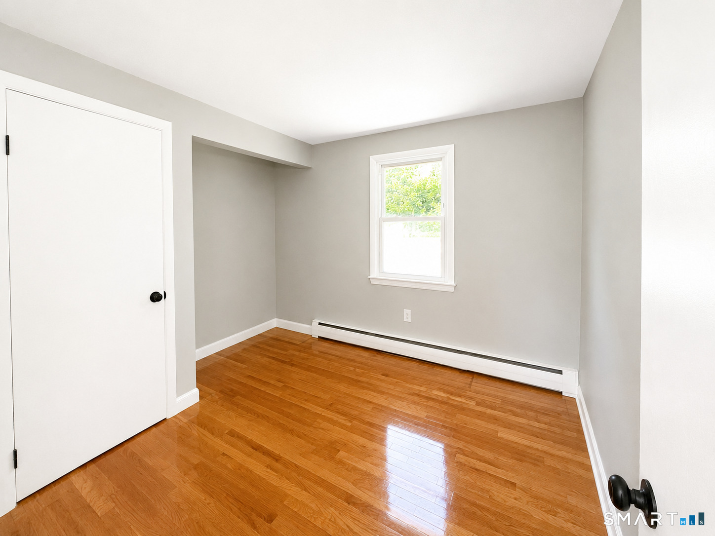 341 Harland Road Norwich, CT 06360 - Photo 16 of 29 a view of an empty room with wooden floor and a window