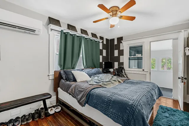 a bedroom with a bed and a television