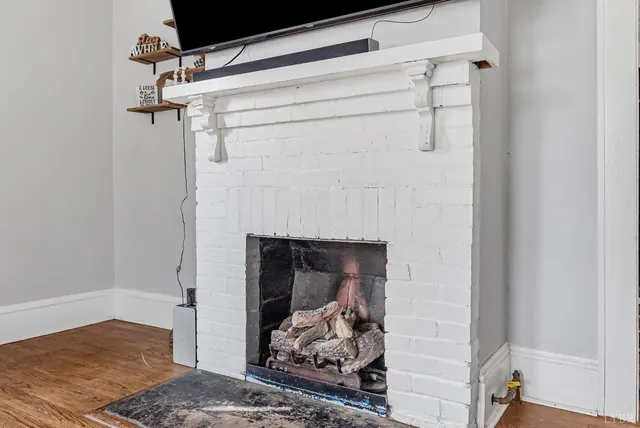 a room with a fireplace and a wooden floor