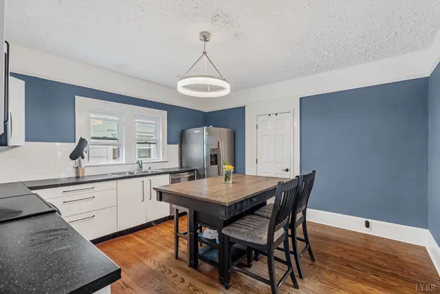 a view of a dining room with a table and chairs
