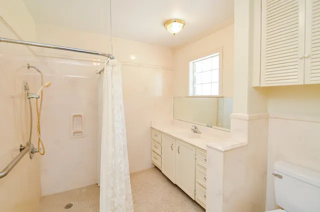 a bathroom with a sink a mirror and a shower