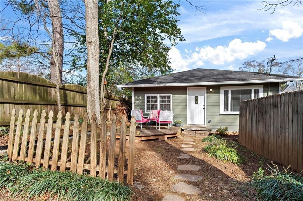 a view of a house with backyard sitting area and garden