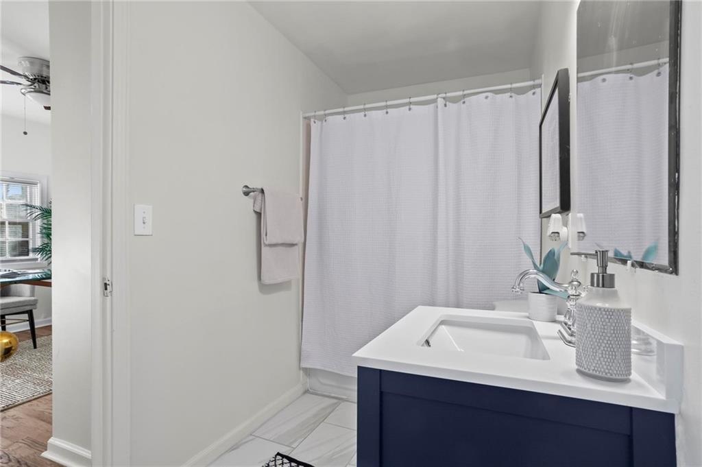 2070 Ridgedale Road Northeast Atlanta, GA 30317 - Photo 11 of 18 a bathroom with a sink and a mirror