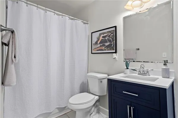 a bathroom with a sink vanity mirror and toilet