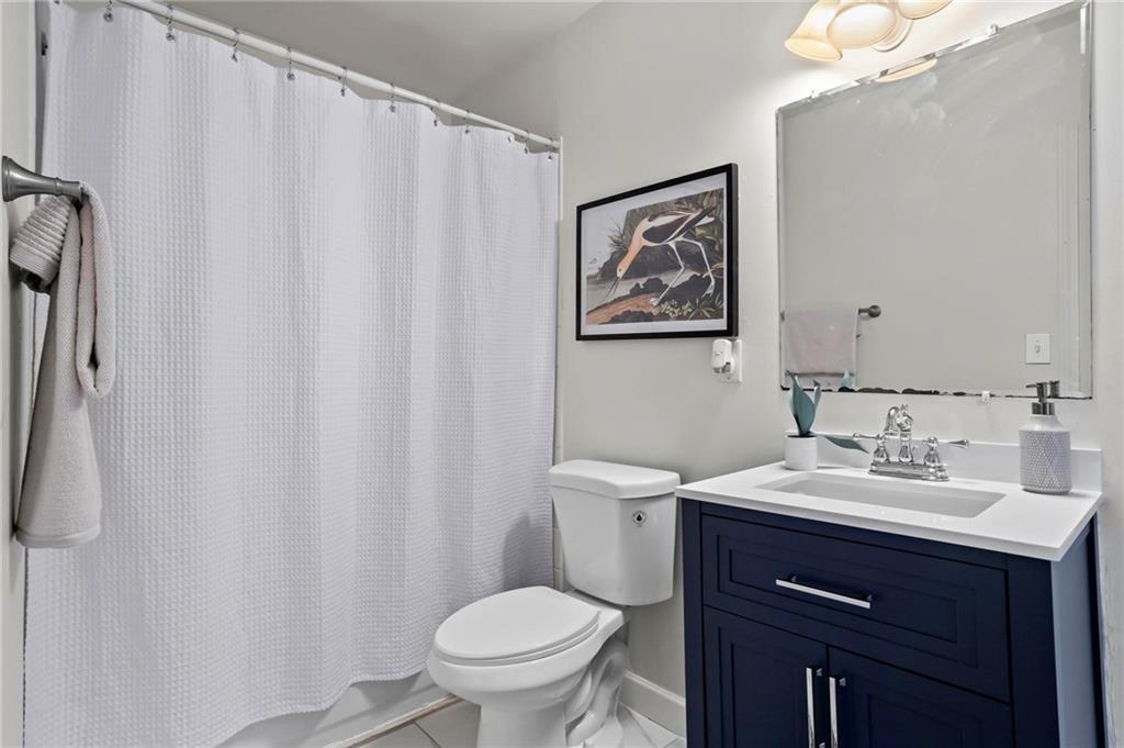 2070 Ridgedale Road Northeast Atlanta, GA 30317 - Photo 12 of 18 a bathroom with a sink vanity mirror and toilet