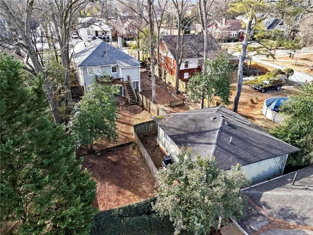 a aerial view of a house with table and chairs under an umbrella