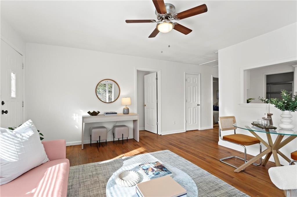 2070 Ridgedale Road Northeast Atlanta, GA 30317 - Photo 4 of 18 a living room with furniture a clock on wall and a table