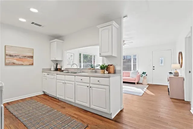 a kitchen with stainless steel appliances granite countertop a sink and cabinets