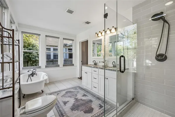 a bathroom with a shower sink and mirror