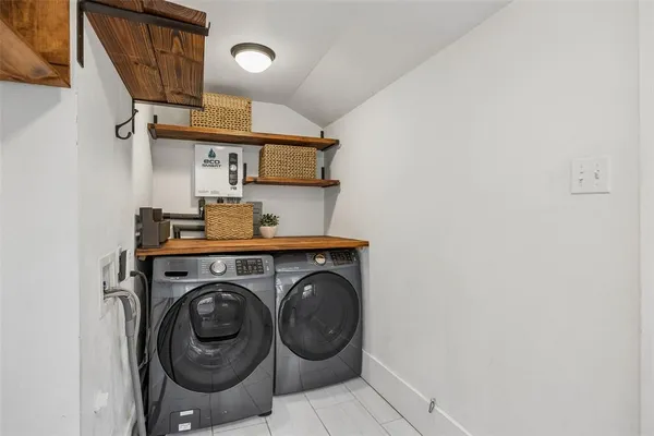 a spacious bathroom with a tub sink mirror and window