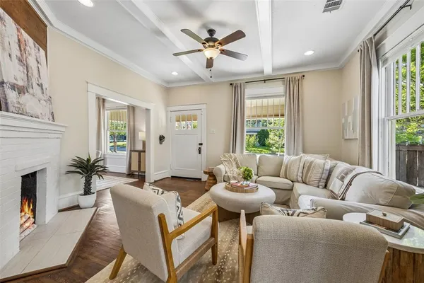 a living room with furniture fireplace and a chandelier