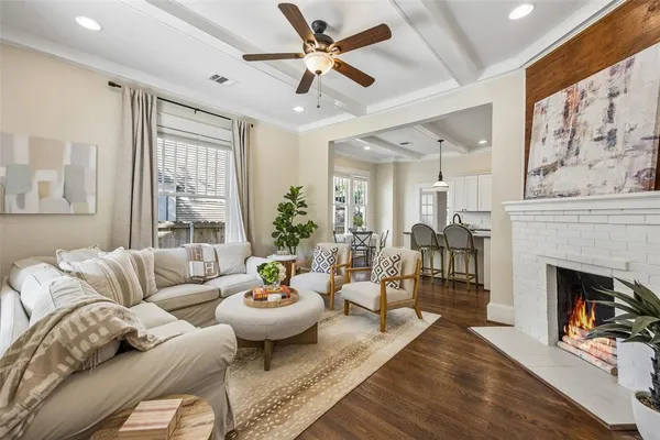 a living room with furniture fireplace and a large window