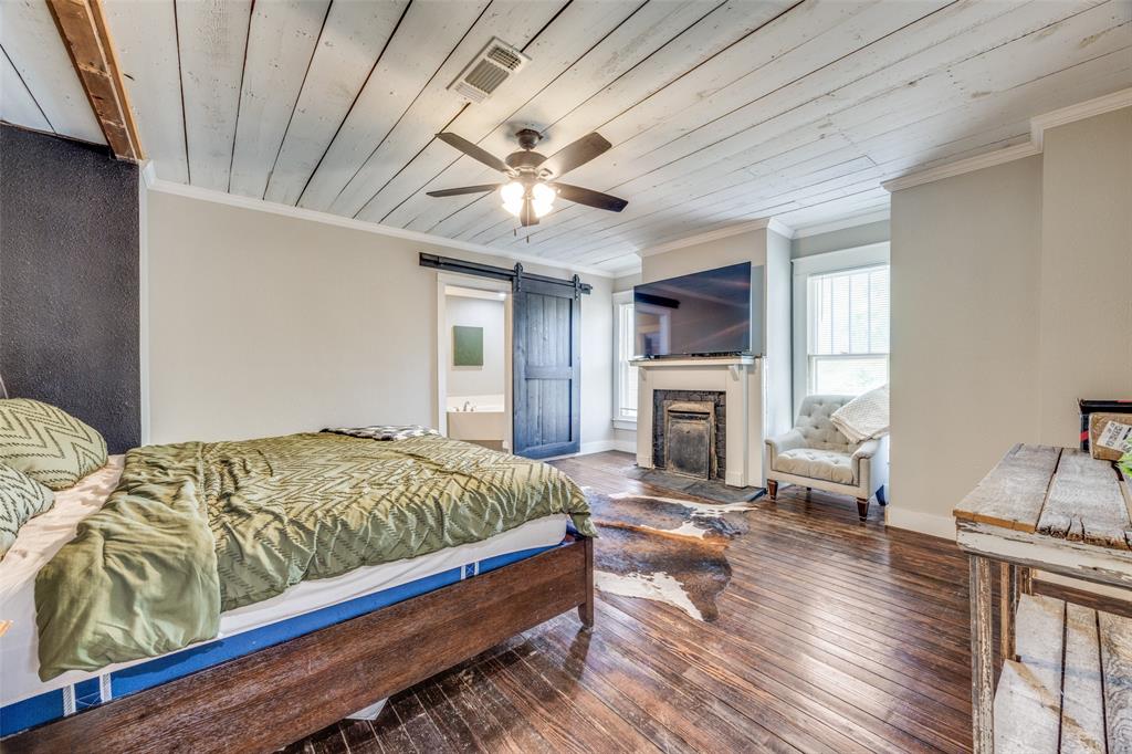 901 North Main Street Leonard, TX 75452 - Photo 15 of 25 a bedroom with bed and wooden floor
