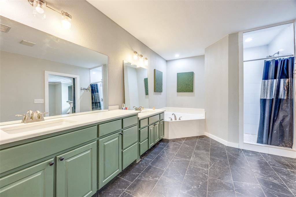 901 North Main Street Leonard, TX 75452 - Photo 17 of 25 a spacious bathroom with a granite countertop sink mirror and bathtub