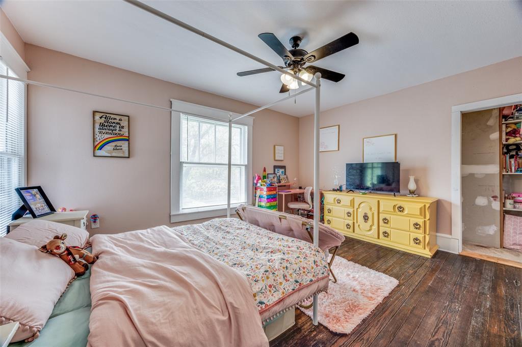 901 North Main Street Leonard, TX 75452 - Photo 19 of 25 a bedroom with a bed a dresser and wooden floor