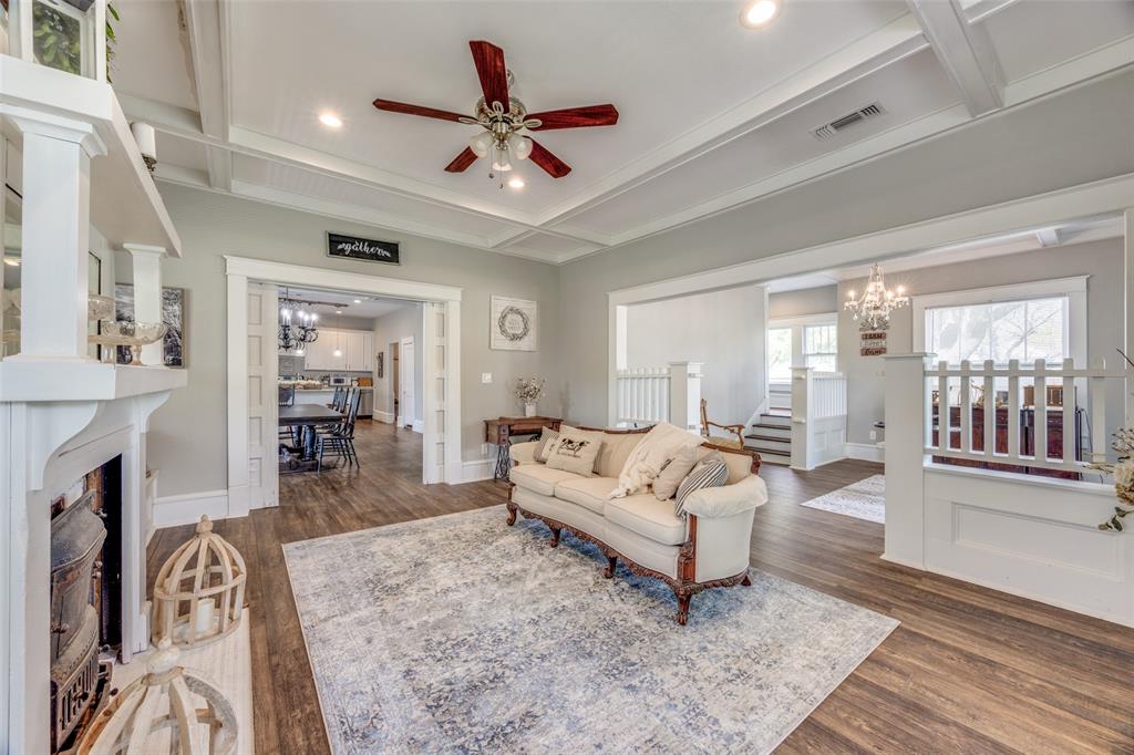 901 North Main Street Leonard, TX 75452 - Photo 5 of 25 a living room with furniture a fireplace and a chandelier