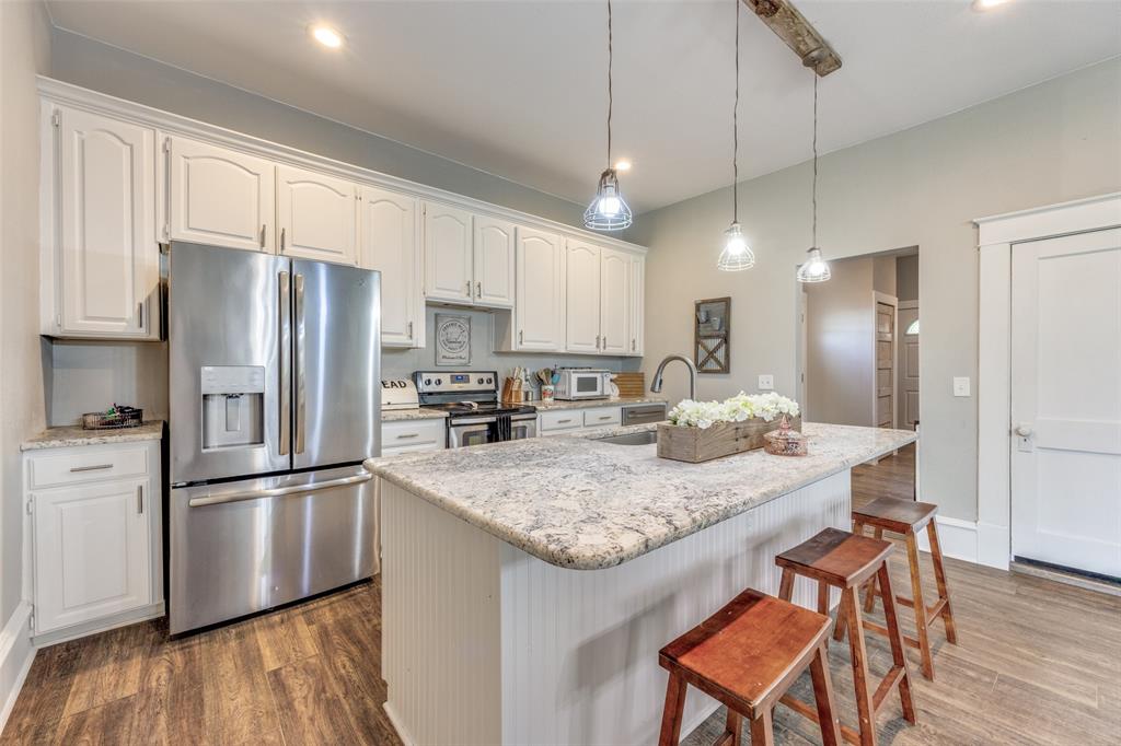 901 North Main Street Leonard, TX 75452 - Photo 9 of 25 a kitchen with stainless steel appliances granite countertop a refrigerator a sink and a stove