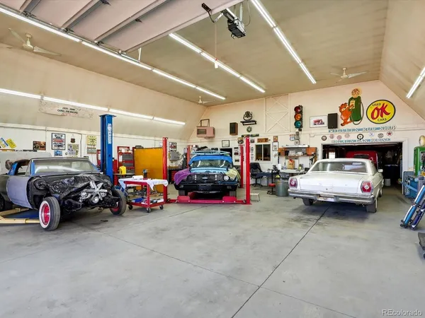 a view of a garage with a car and a cycle