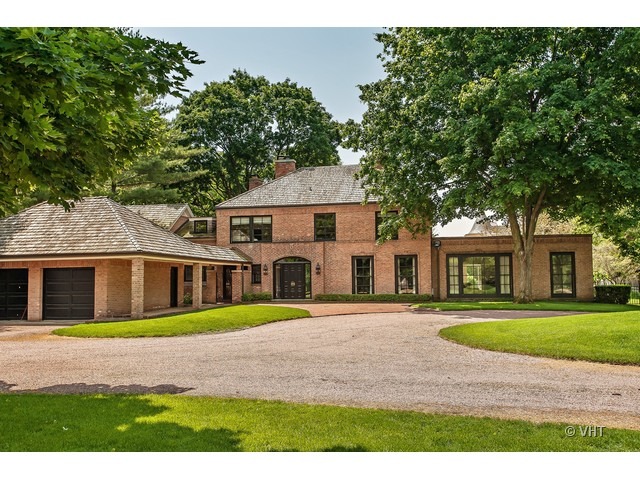 76 Locust Road Winnetka, IL 60093 - Photo 1 of 25 a front view of a house with a yard and trees
