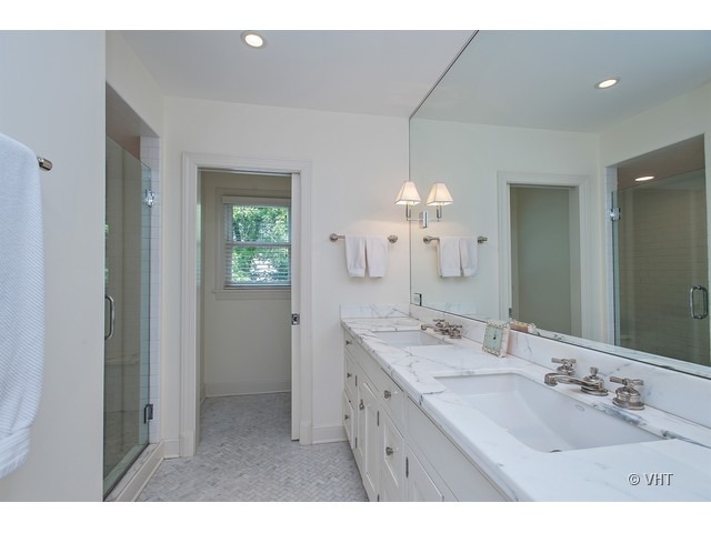76 Locust Road Winnetka, IL 60093 - Photo 13 of 25 a bathroom with a double vanity sink and a mirror