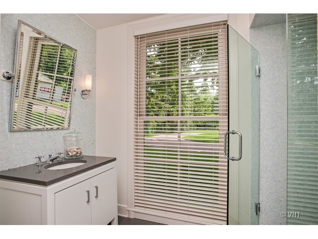 76 Locust Road Winnetka, IL 60093 - Photo 16 of 25 a bathroom with a granite countertop sink and a window