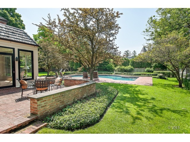 76 Locust Road Winnetka, IL 60093 - Photo 19 of 25 a view of a house with swimming pool and sitting area
