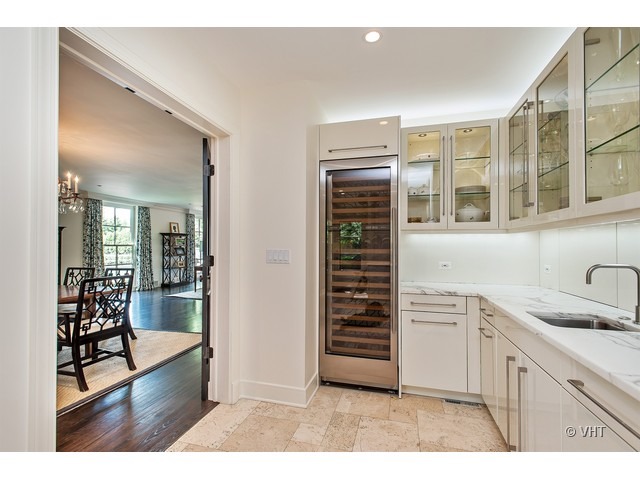 76 Locust Road Winnetka, IL 60093 - Photo 6 of 25 a kitchen with granite countertop a sink and cabinets